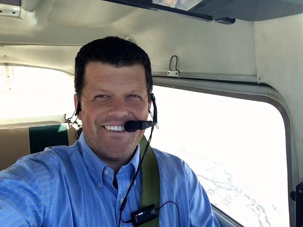 Austin Blanco smiling in the cockpit of his plane, wearing a headset