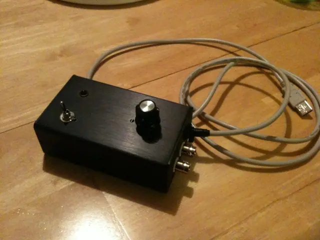 The finished black control box with a knob and cable