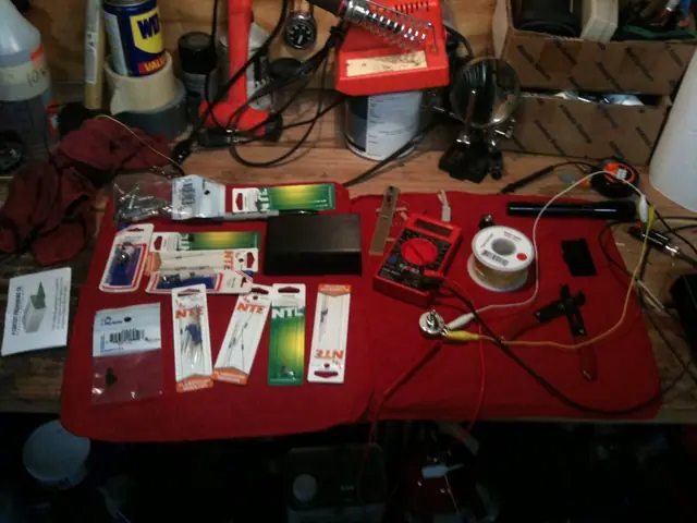 A workbench covered in parts for a custom control box