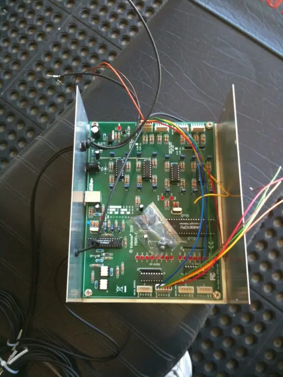 The inside of a TTL control box with a green circuit board